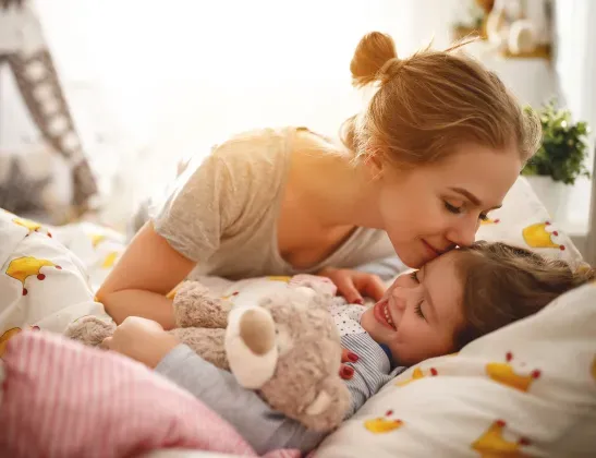 mom-tucking-kid-into-bed